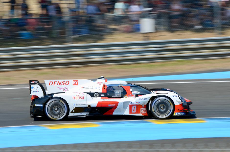 Dynamic Toyota Hybrid racing car in action at the 24 Hours of Le Mans, showcasing speed and precision.