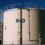 Large industrial storage tanks under blue skies, highlighting metal structures.