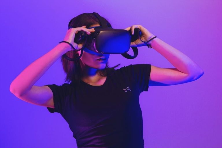 Woman wearing virtual reality headset immersed in a vibrant neon-lit gaming experience.