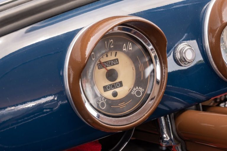 Close-up of a vintage car dashboard showcasing a classic fuel and oil gauge.