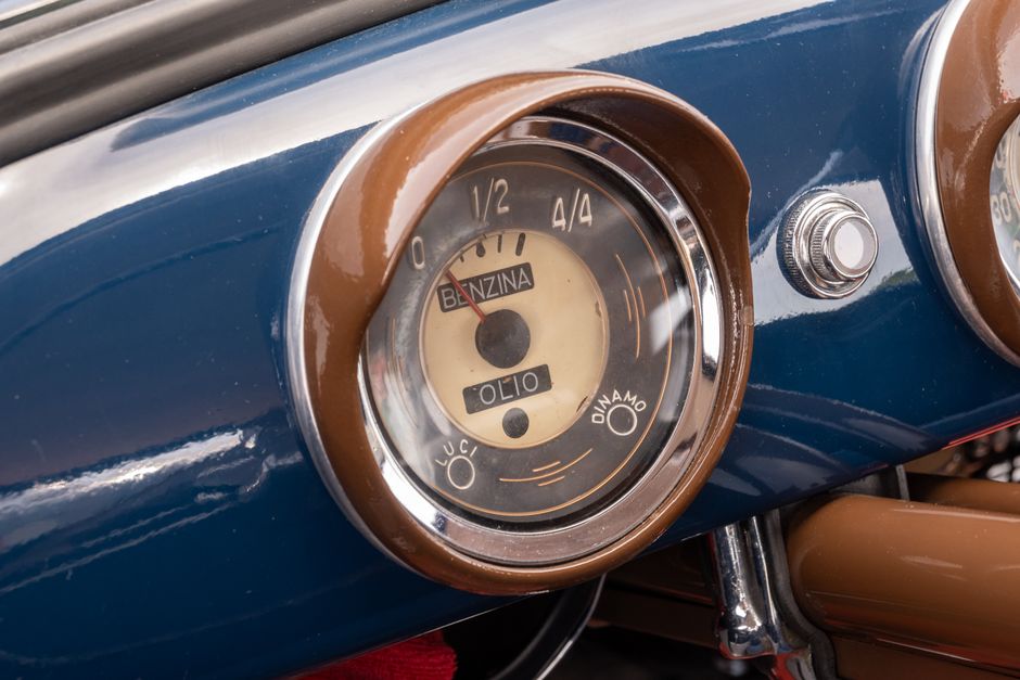 Close-up of a vintage car dashboard showcasing a classic fuel and oil gauge.