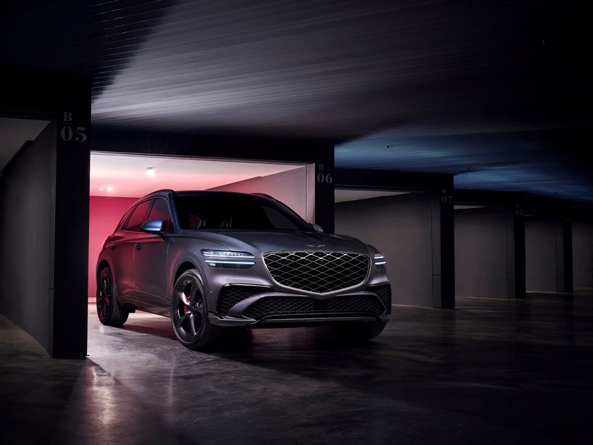 Modern Genesis GV70 SUV parked stylishly in a contemporary garage setting.