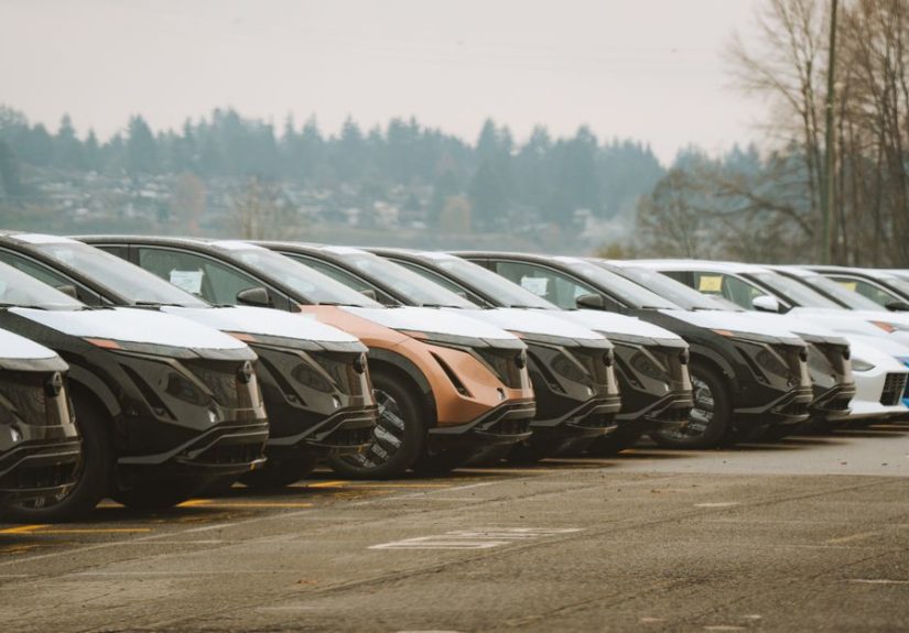 Rows of sleek electric cars parked outdoors, showcasing automotive design and innovation.
