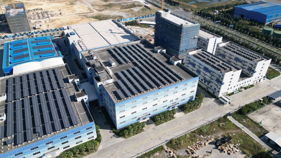 Industrial buildings with solar panels, aerial view showcasing renewable energy.