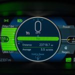 Detailed view of an electric vehicle's dashboard showing speed, battery range, and power metrics.