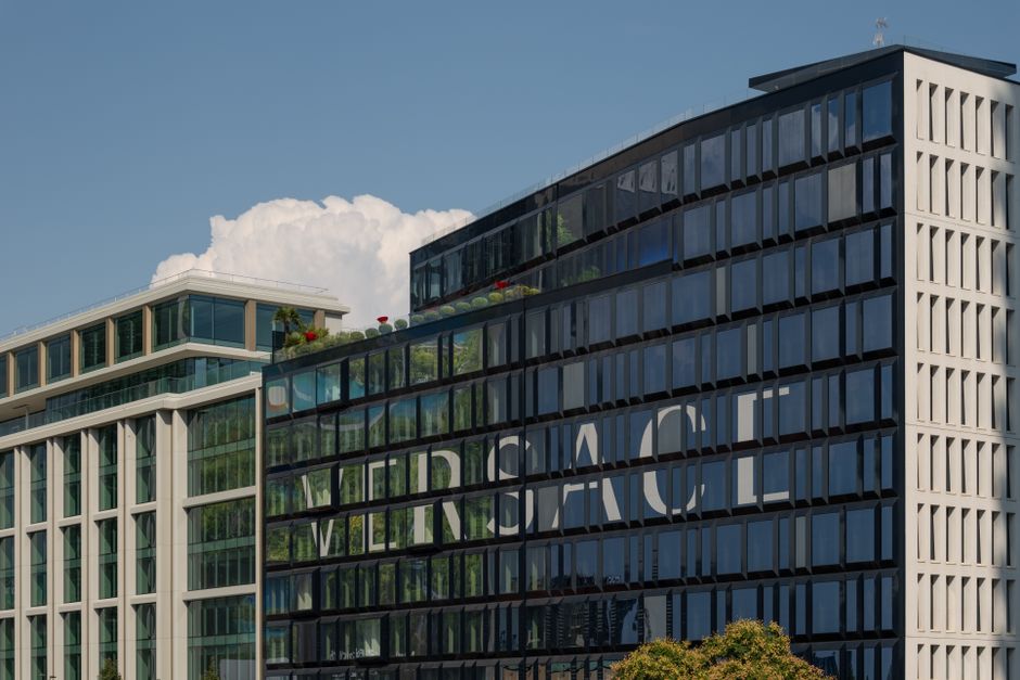 A view of the modern Versace headquarters in Milan, Italy, against a clear blue sky, showcasing its sleek architectural design.
