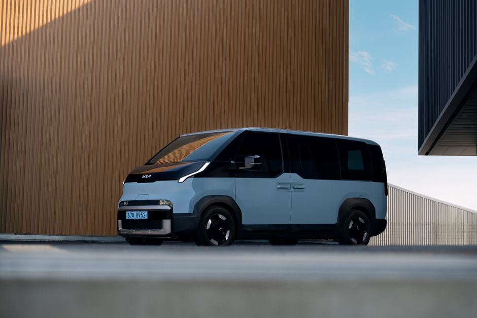 Modern electric vehicle parked outdoors showcasing sleek design and contemporary architecture.