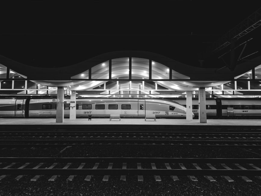 Black and white photo of Eskişehir train station at night, showcasing architectural design.