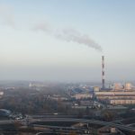 Aerial shot of a power plant emitting smoke, highlighting urban air pollution and industrial impact.