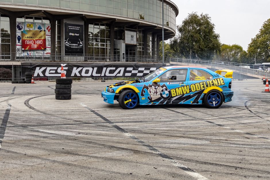 Colorful drift car performing stunts outside Belgrade Fair in Serbia, showcasing speed and precision.