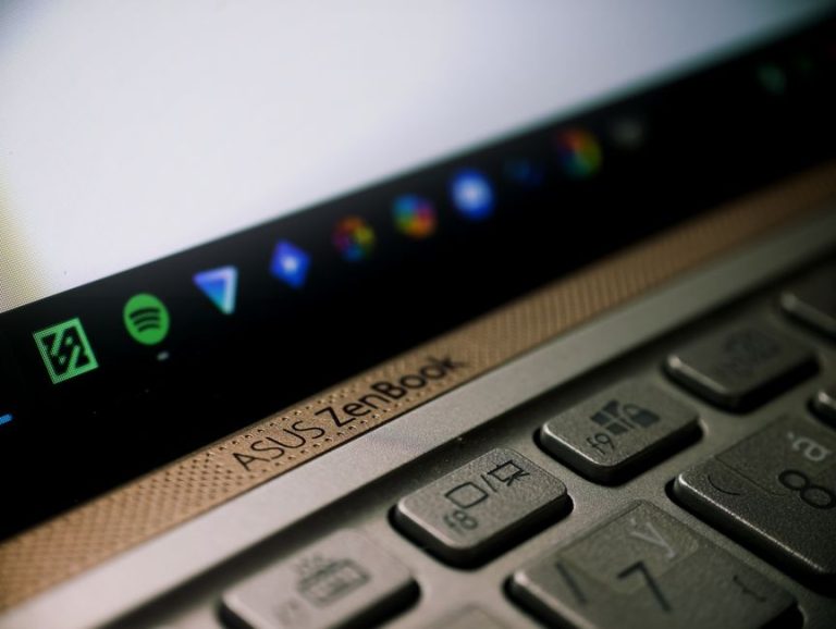A detailed close-up of an ASUS ZenBook laptop keyboard and screen, showcasing technology in modern workspaces.