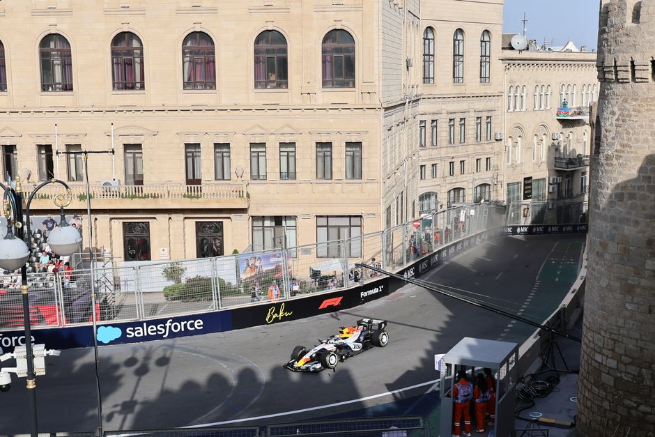 Exciting Formula 1 race scene at Baku City Circuit, showcasing high-speed action and historic architecture.