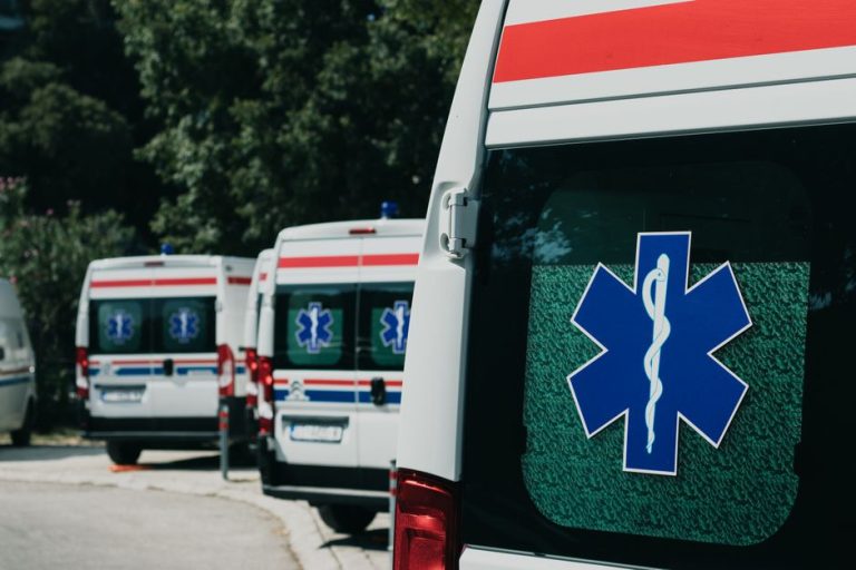 Three ambulances parked outdoors, ready for emergency healthcare situations.