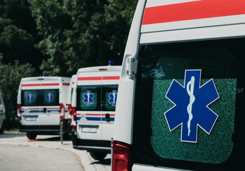 Three ambulances parked outdoors, ready for emergency healthcare situations.