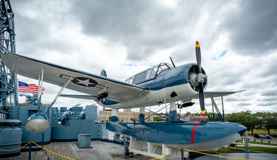 A vintage aircraft displayed on a battleship deck in Wilmington, NC.