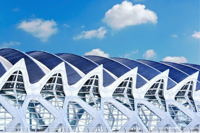A striking futuristic building design under a bright blue sky in Madrid, Spain.