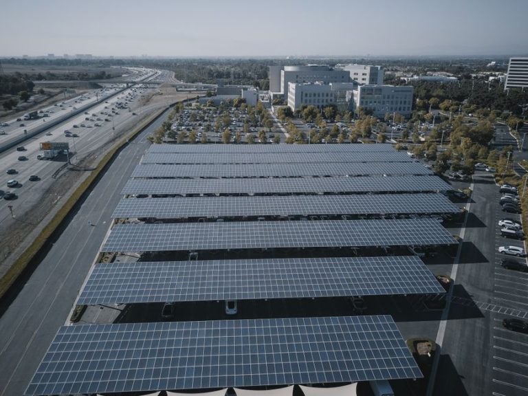 Aerial view of extensive solar panels in an urban setting, showcasing renewable energy.