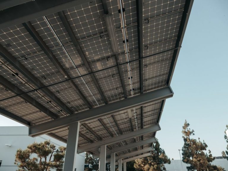 Low-angle view of solar panels under a clear sky, highlighting clean energy.