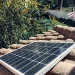 Close-up of a solar panel installed on a tiled roof, capturing clean energy.