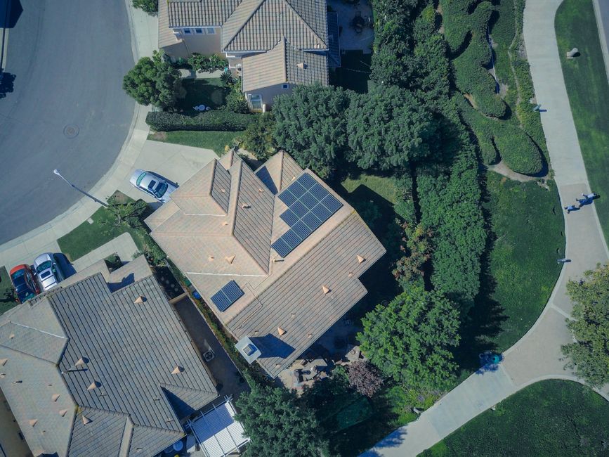 An aerial view showcasing modern suburban houses equipped with solar panels for renewable energy.