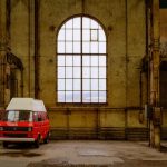 Red vintage Volkswagen van parked in an old industrial warehouse in Winterthur, Switzerland.