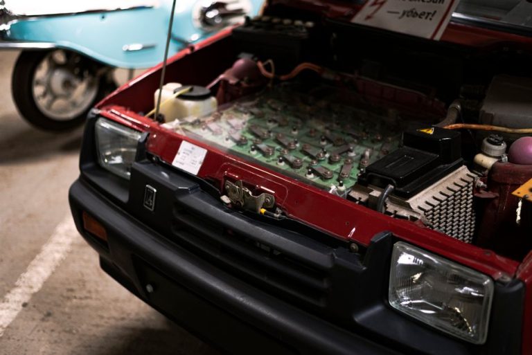 Detailed close-up of a car engine under the hood showcasing various components and connections.
