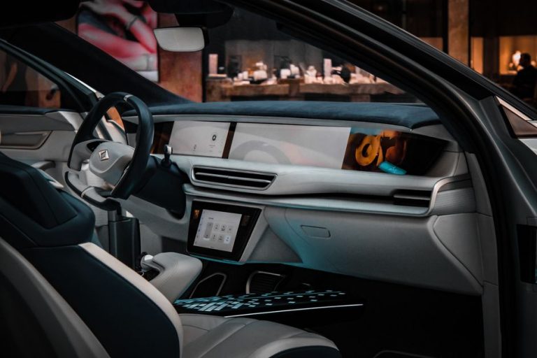 Explore the sleek and modern design of a luxury car interior, showcasing advanced technology and premium materials.