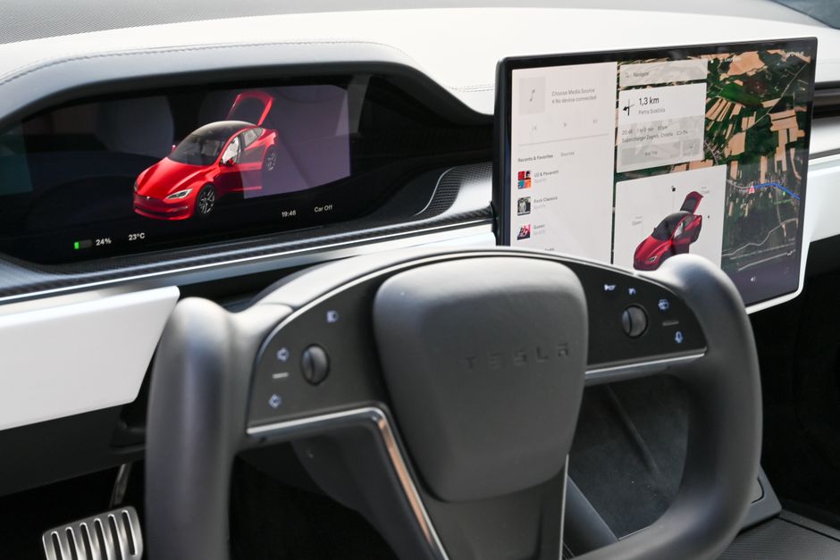 Explore the sleek interior of a modern electric car featuring advanced touchscreens and innovative steering design.