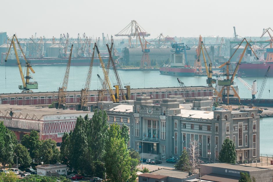 Industrial cranes and buildings at Constanța Port during daytime, Romania's bustling hub.