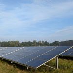 Solar panels in a Ratzeburg field, capturing renewable energy on a clear day.