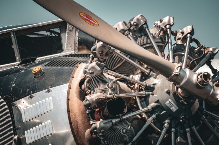 Detailed view of a vintage aircraft engine and propeller showcasing intricate mechanical design.