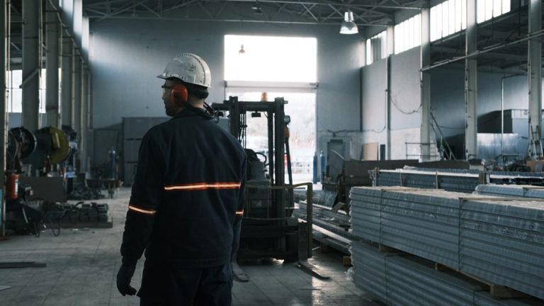 A worker in protective gear supervises operations in a modern Ankara factory.