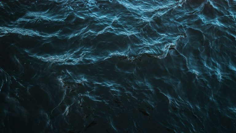 A dynamic capture of blue ocean waves flowing with natural energy.