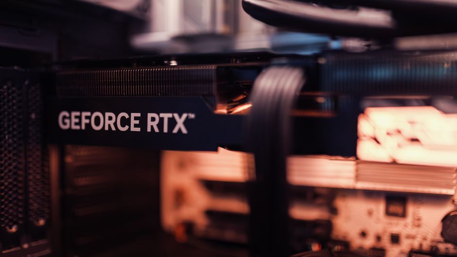 Detailed view of a GeForce RTX graphics card installed in a computer setup, highlighting modern technology.