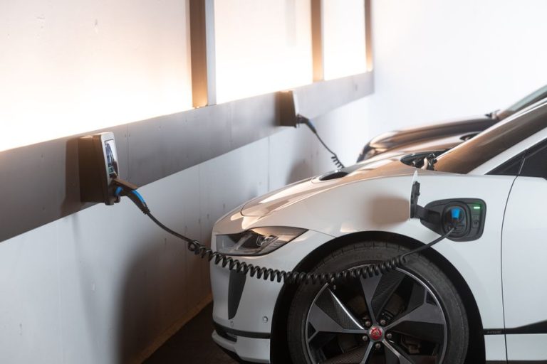 Electric car charging in a modern indoor station promoting sustainability and energy efficiency.