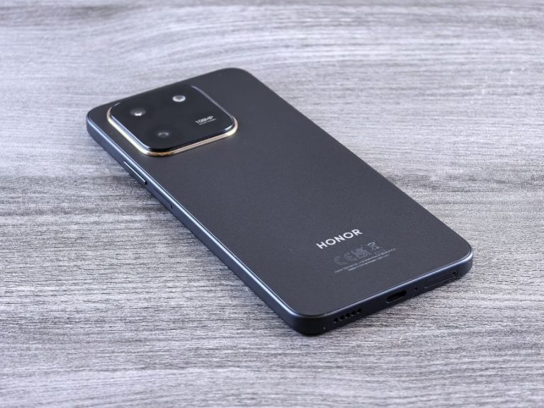 Close-up of a modern smartphone with a sleek design on a wooden surface.