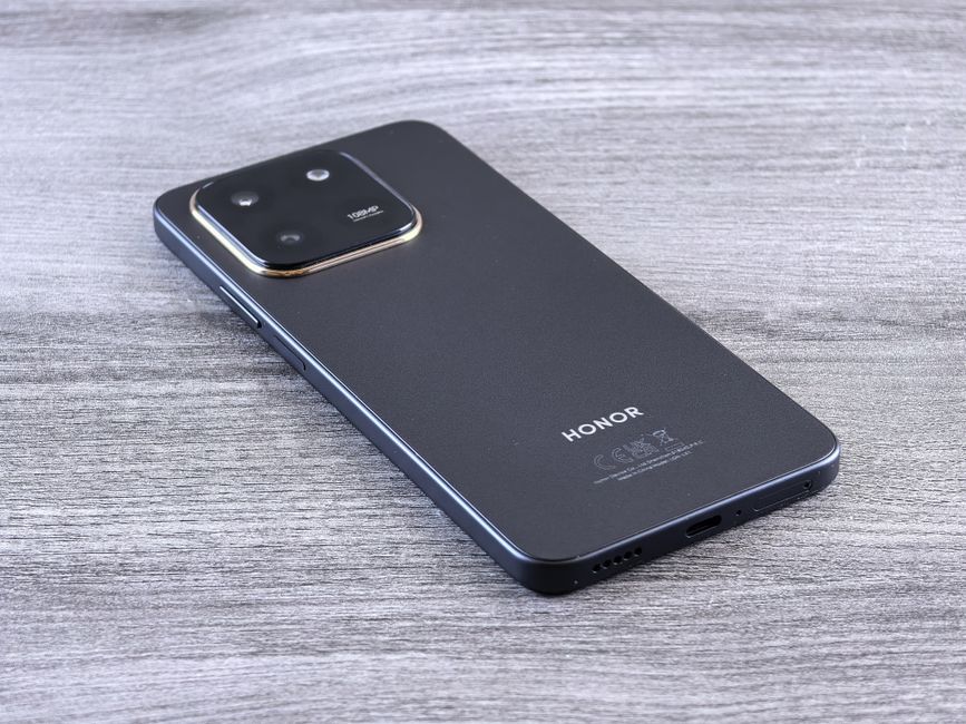 Close-up of a modern smartphone with a sleek design on a wooden surface.