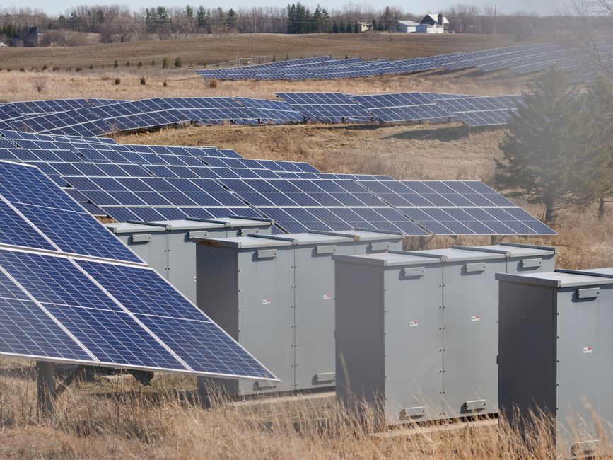 Expansive solar panel field in a rural area harnessing solar energy. Sustainable and renewable energy source.