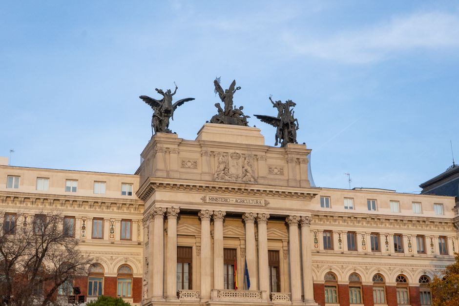 Front view of Spain’s Ministry of Agriculture with angel statues atop in Madrid.