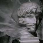 Statue covered with plastic highlighting environmental concerns.