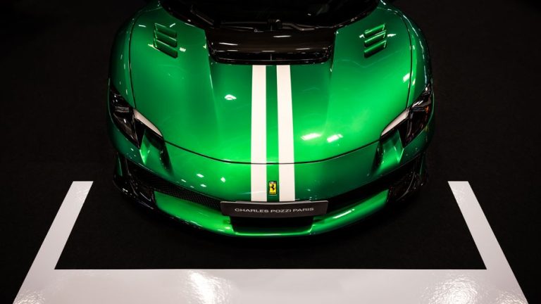 Overhead view of a vibrant green luxury sports car with white racing stripes.