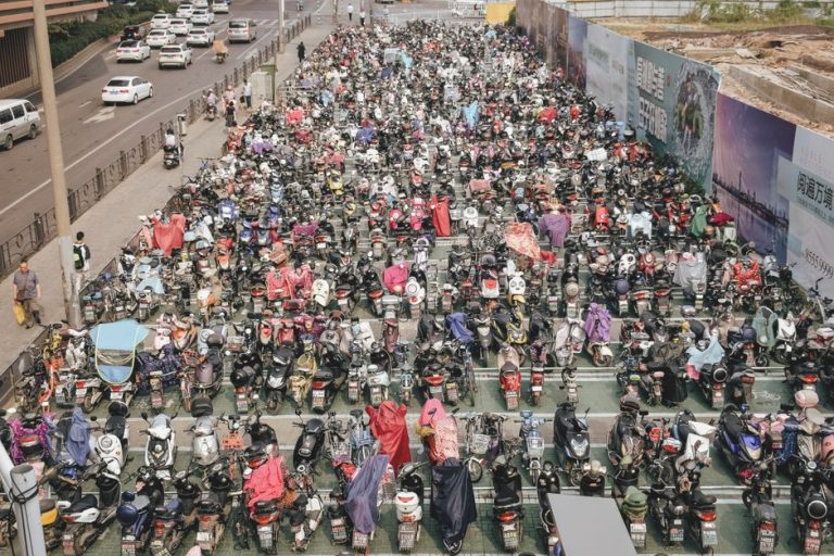 Crowded scooter parking in Nanjing, showcasing urban bike culture in China.