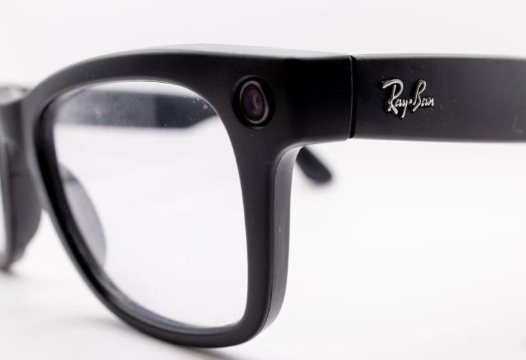 Detailed close-up shot of black smart glasses featuring a built-in camera, highlighting modern technology and design.