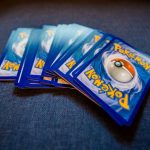 From above of pack of collectible cards with images of fantastic creatures on backs located on gray backdrop