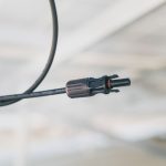 Detailed close-up shot of an electrical connector cable with a blurred background.